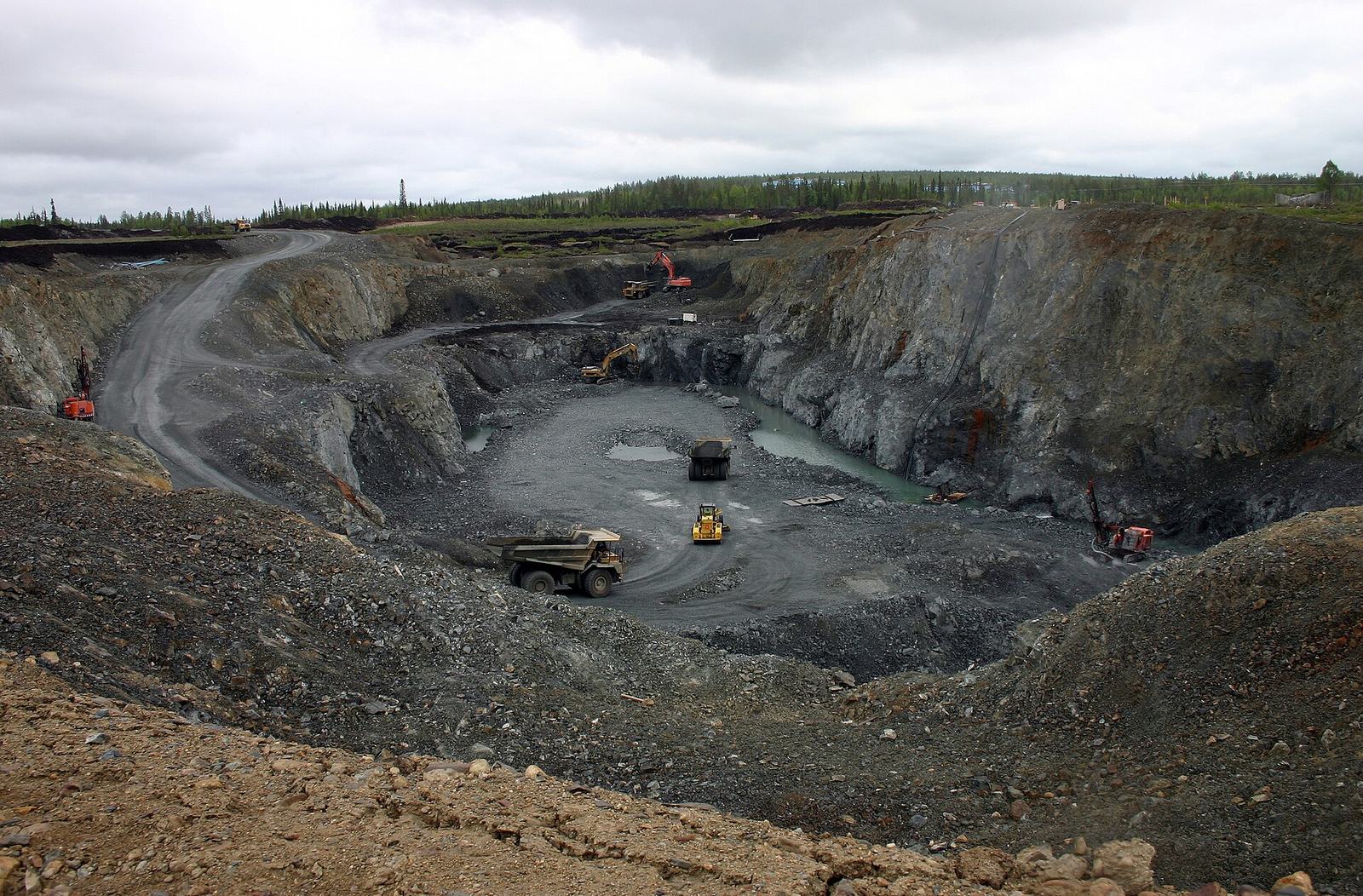 Open-pit mine with haul trucks on the benches
